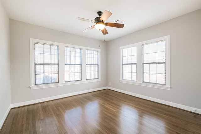 spare room featuring ceiling fan and dark wood-type flooring