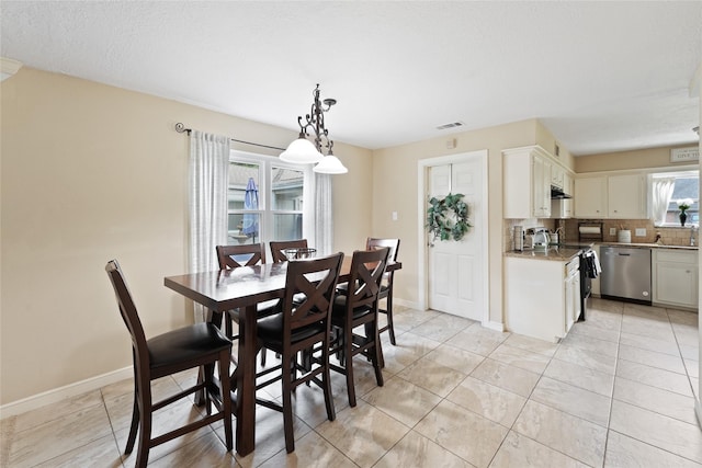 tiled dining space with a textured ceiling