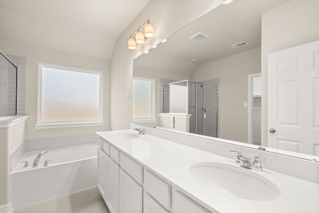 bathroom featuring plus walk in shower, vanity, lofted ceiling, and tile patterned flooring