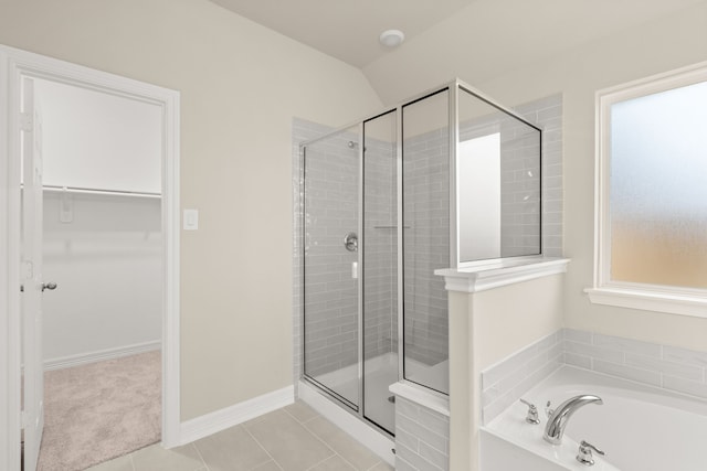 bathroom featuring tile patterned flooring and shower with separate bathtub