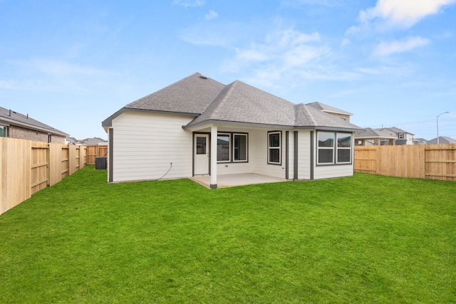 back of house featuring a patio area and a lawn