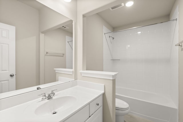 full bathroom with vanity, tiled shower / bath, and toilet