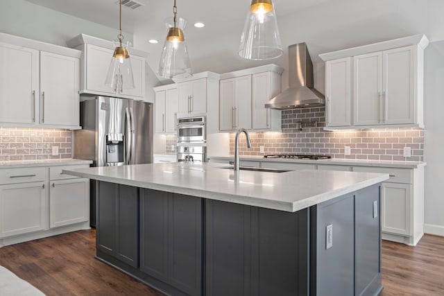 kitchen with pendant lighting, white cabinetry, dark hardwood / wood-style flooring, and wall chimney range hood