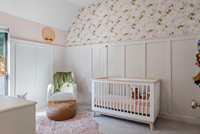 carpeted bedroom featuring a crib