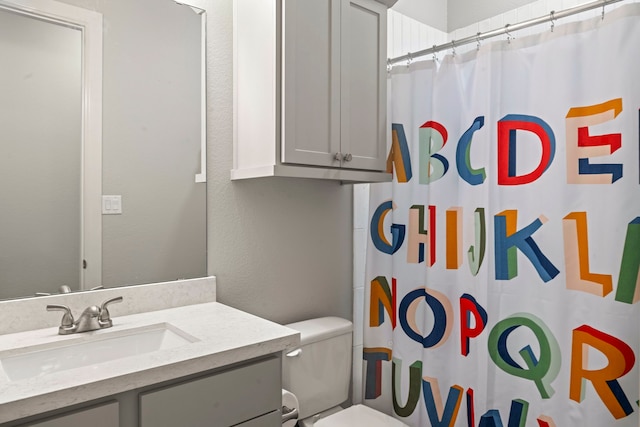 bathroom with a shower with curtain, vanity, and toilet