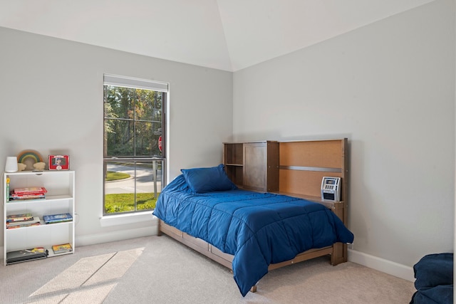 carpeted bedroom with vaulted ceiling