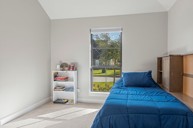 carpeted bedroom with lofted ceiling