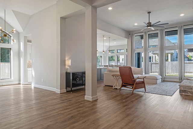 living room featuring hardwood / wood-style floors and ceiling fan with notable chandelier