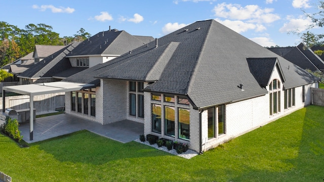 rear view of house with a patio area and a yard