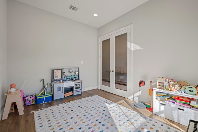 recreation room featuring french doors and dark hardwood / wood-style flooring