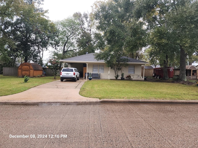 view of front of house with a front lawn, a shed, and a garage