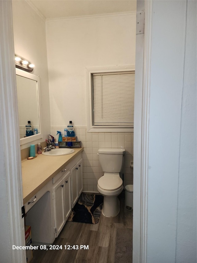 bathroom with hardwood / wood-style floors, vanity, toilet, and crown molding