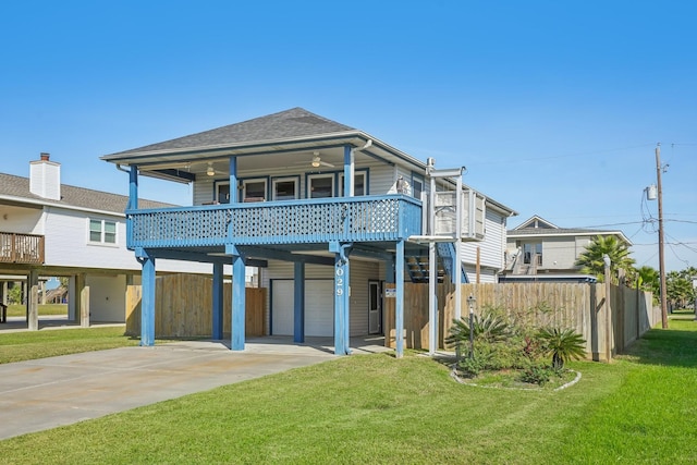 rear view of house with a yard, a garage, and a carport