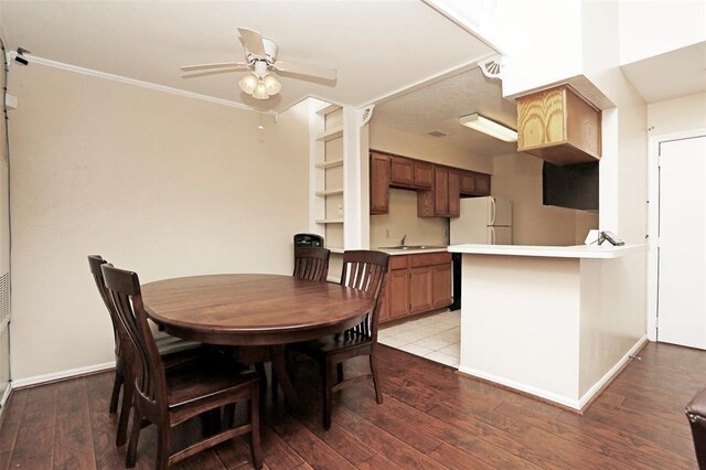 dining area with ceiling fan, light hardwood / wood-style flooring, and sink