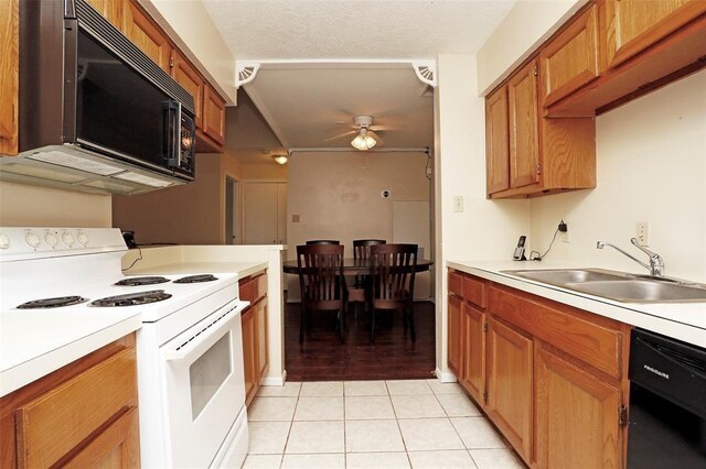 kitchen featuring ceiling fan, sink, a textured ceiling, light tile patterned flooring, and black appliances