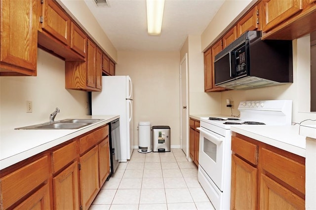 kitchen with sink, light tile patterned floors, and black appliances