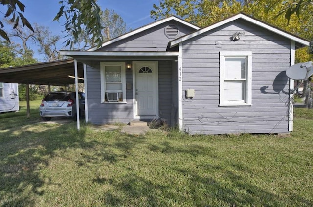 view of front of home featuring a carport, cooling unit, and a front lawn