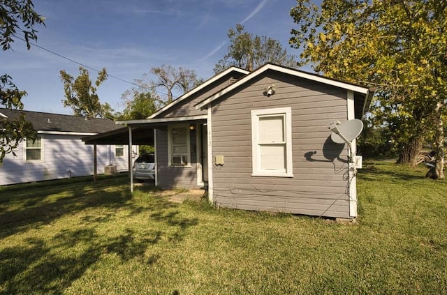 view of outdoor structure featuring a yard and a carport