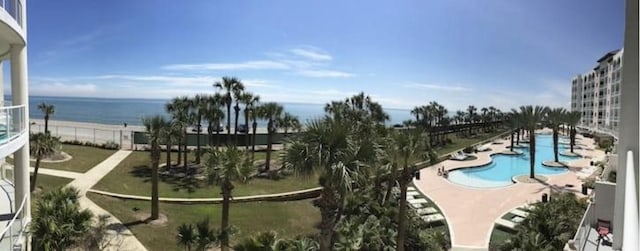 view of swimming pool featuring a water view and a patio area