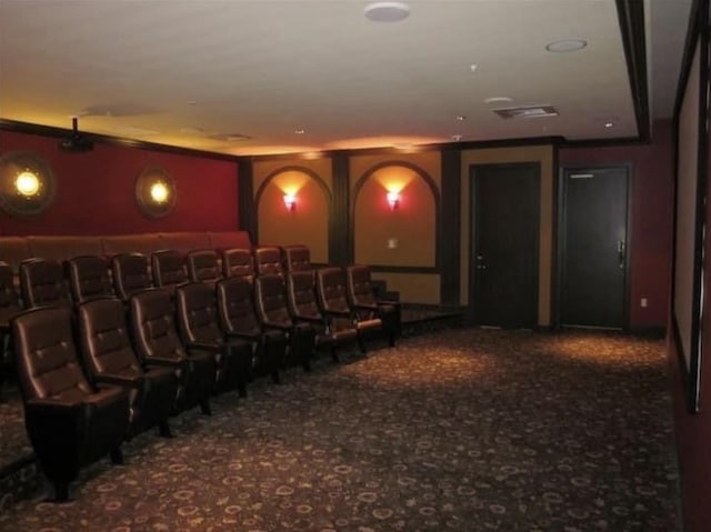 carpeted cinema featuring ornamental molding