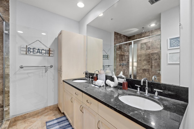 bathroom featuring tile patterned floors, vanity, and a shower with shower door