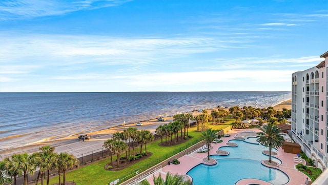 view of pool with a beach view and a water view