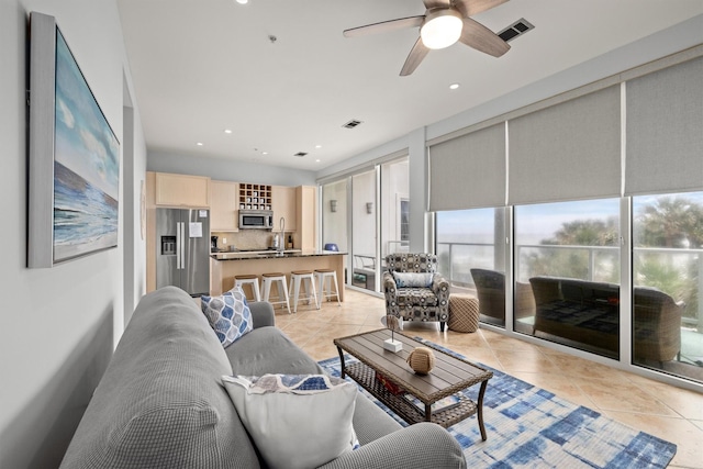 tiled living room featuring ceiling fan