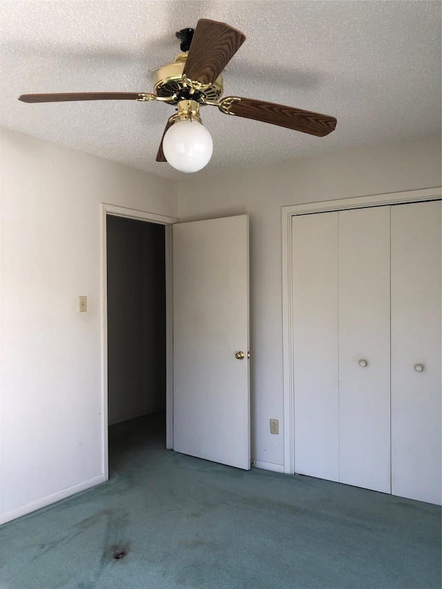 unfurnished bedroom featuring a textured ceiling, a closet, ceiling fan, and carpet flooring