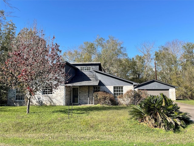 view of front of property with a garage and a front lawn