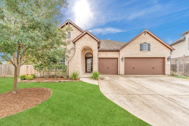 view of front of home with a front lawn and a garage