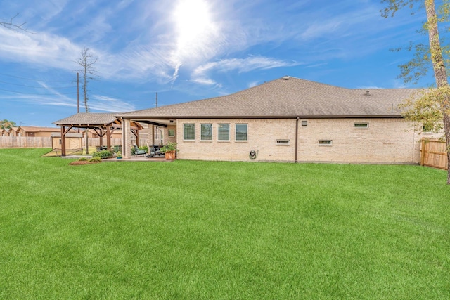 back of house featuring a lawn, a gazebo, and a patio