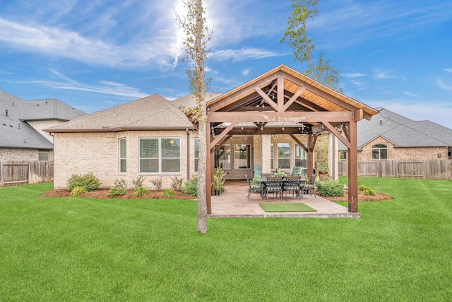 rear view of property featuring a gazebo, a patio area, and a yard