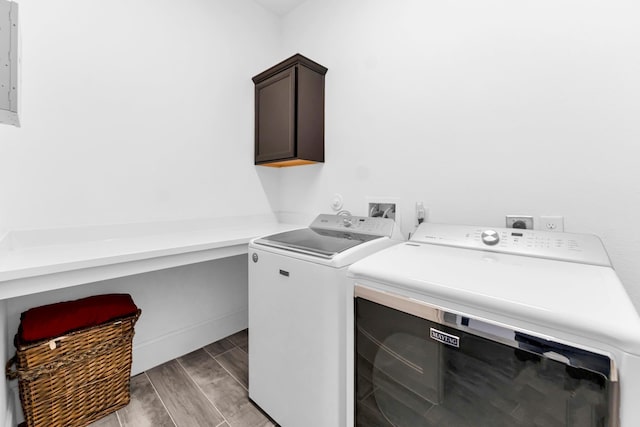 washroom featuring cabinets and independent washer and dryer