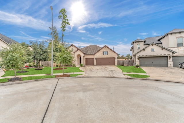 view of front of property with a front yard and a garage