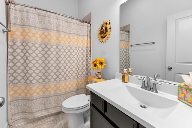 bathroom featuring toilet and vanity