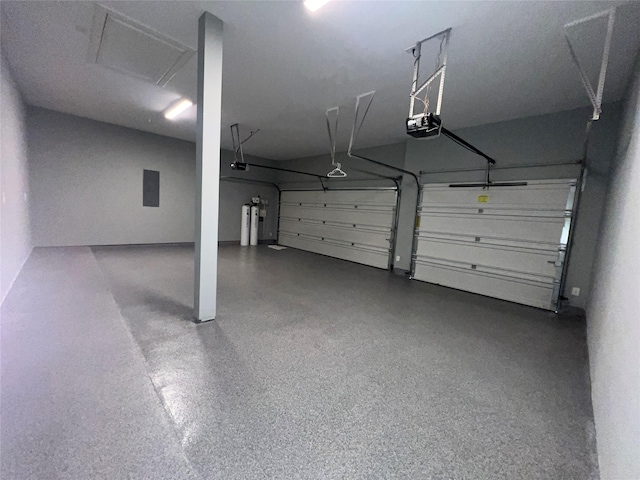 garage featuring water heater and a garage door opener