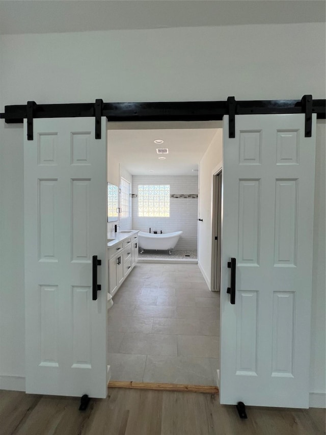 24555 Kerry St, Hempstead, TX 77445 - bathroom featuring a freestanding tub, vanity, and wood finished floors