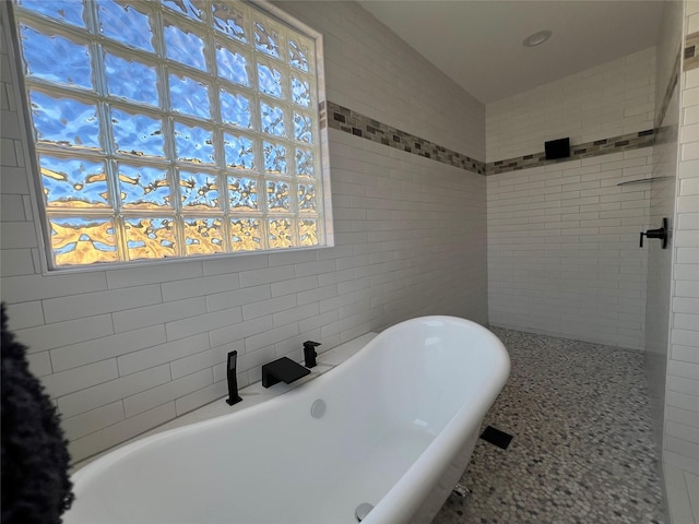 24555 Kerry St, Hempstead, TX 77445 - bathroom with a freestanding tub and tile walls