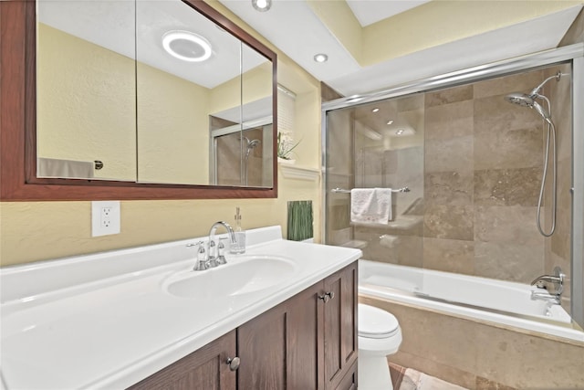 full bathroom with vanity, enclosed tub / shower combo, and toilet