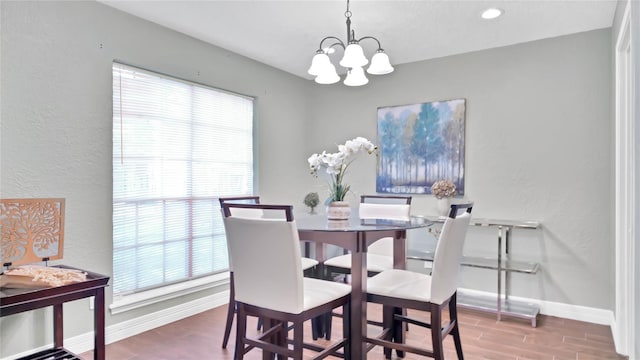 dining space featuring a notable chandelier and wood-type flooring