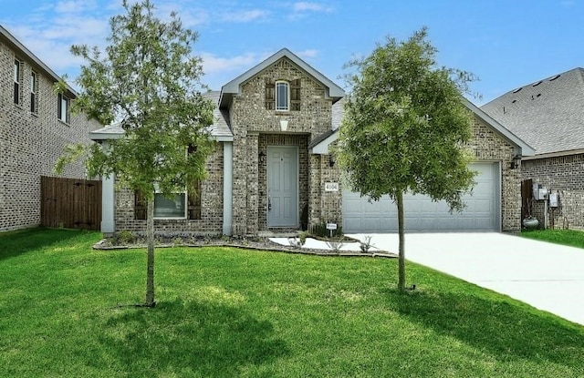 view of front of property featuring a front yard and a garage