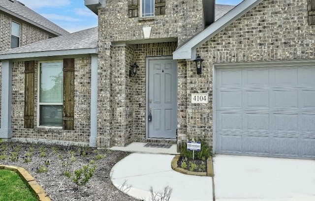 view of exterior entry with a garage