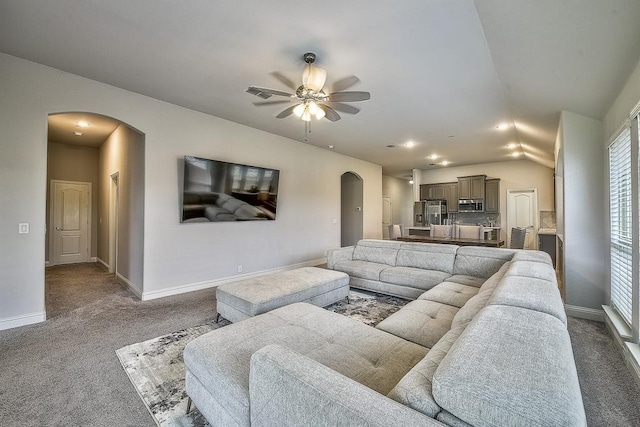 carpeted living room with ceiling fan and lofted ceiling