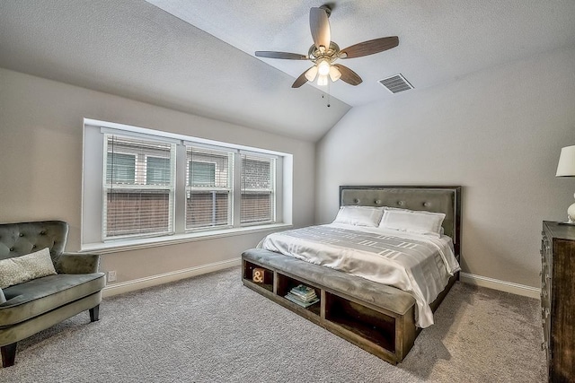 bedroom featuring carpet flooring, ceiling fan, a textured ceiling, and vaulted ceiling