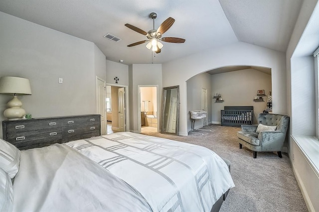 carpeted bedroom featuring ensuite bathroom, ceiling fan, and vaulted ceiling