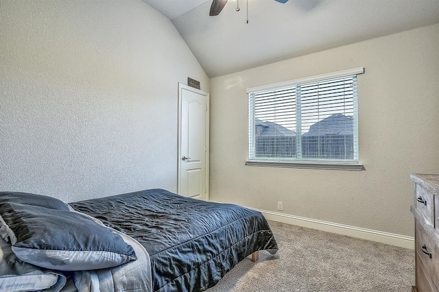 carpeted bedroom with ceiling fan and vaulted ceiling