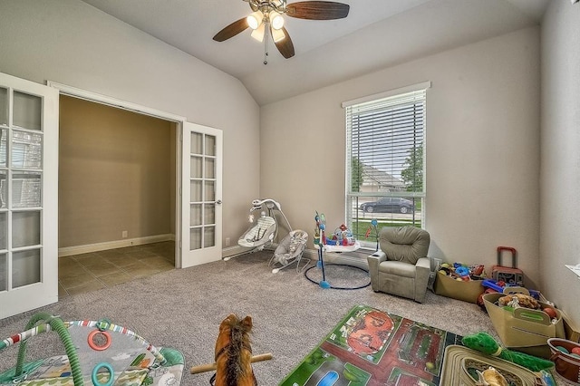 playroom with ceiling fan, light colored carpet, lofted ceiling, and french doors