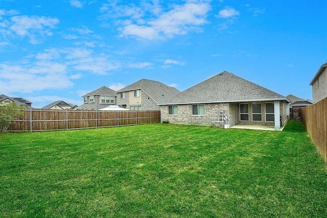 back of house featuring a yard and a patio