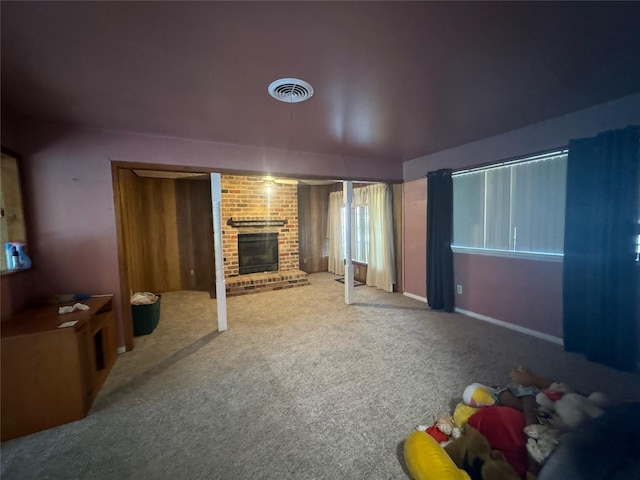 living room featuring carpet flooring and a brick fireplace