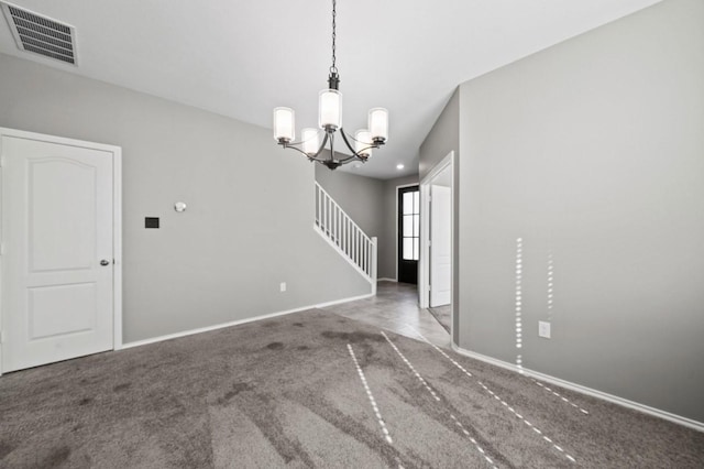 unfurnished room with carpet and a notable chandelier